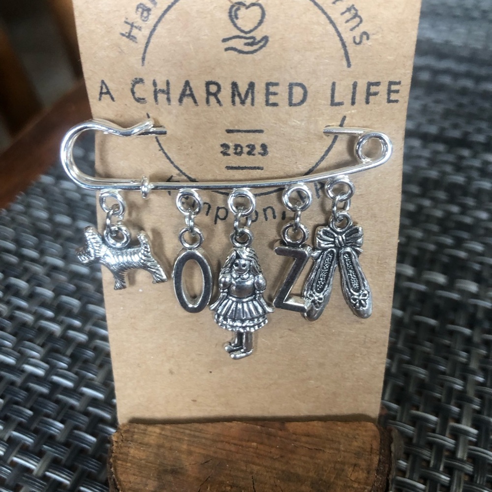 NWT, Handmade by A Charmed Life. Wizard of Oz Silver Charms/Silver 2” Pin